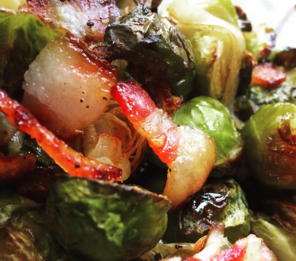 Roasted Brussels sprouts with bacon, shallots, and garlic.